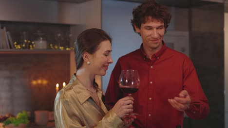 couple enjoying a glass of red wine together at home