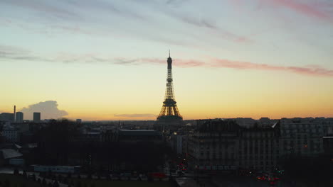 Landing-footage-in-park-in-large-city.-Silhouette-of-Eiffel-Tower-against-colourful-twilight-sky.-Paris,-France