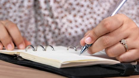 person writing in a notebook