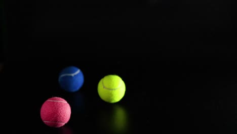 three tennis balls bouncing in the air