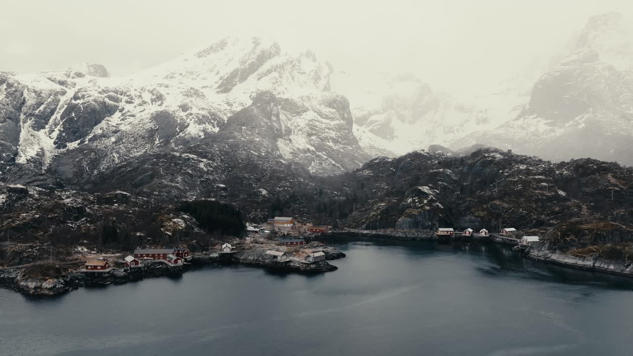 Fishing Village With Snow Mountains In Nusfjord, Flakstad Municipality, Lofoten In Nordland County, Norway. Aerial Drone Shot