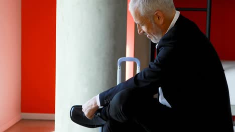 businessman tying shoelaces in hotel room 4k