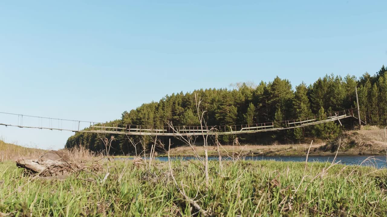 Old Suspension Bridge Over River in Forest
