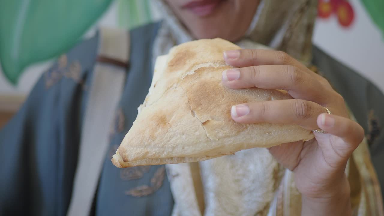 Woman eating a piece of bread