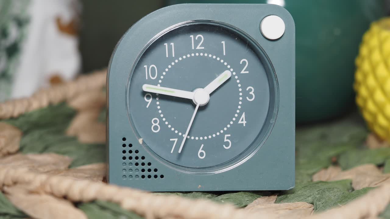Close-up of a Teal Analog Alarm Clock