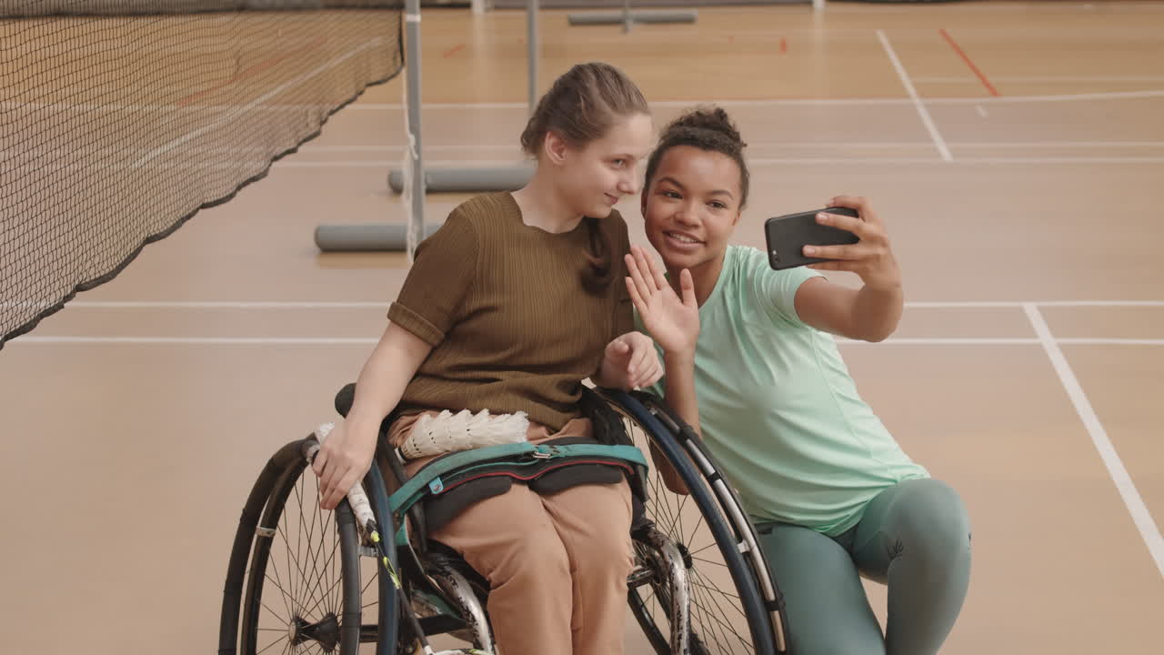 Athlete Taking Selfie with Girl in Wheelchair