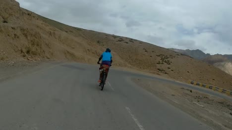 biker speeding on the mountain curssing road to leh in ladakh, india - rolling shot