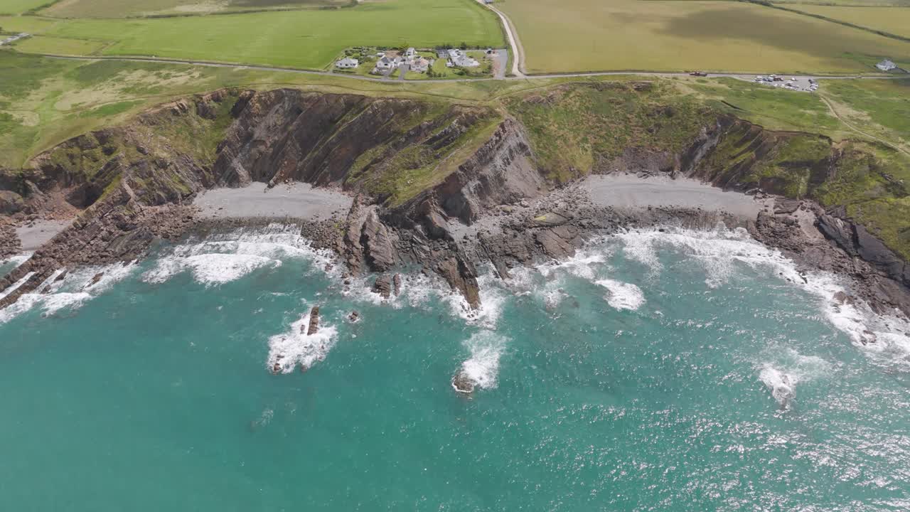 Aerial view of a rocky coastline with waves crashing on the shore