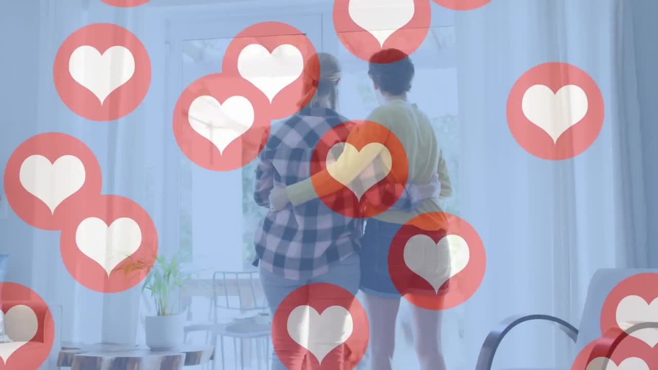 사랑에 빠진 행복한 백인 여성 커플이 포옹하는 심장 이모티콘의 애니메이션