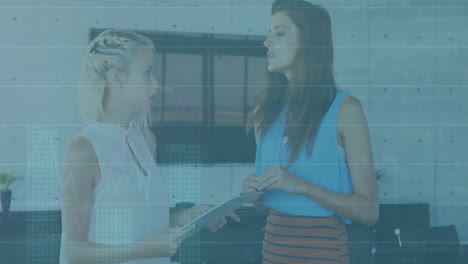 Animation of statistical data processing over two diverse female colleagues discussing at office