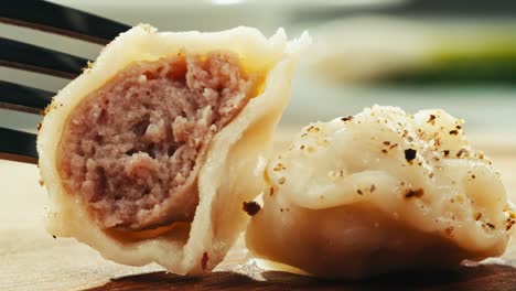 meat filled dumplings on a fork