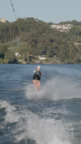 woman wakeboarding on a river