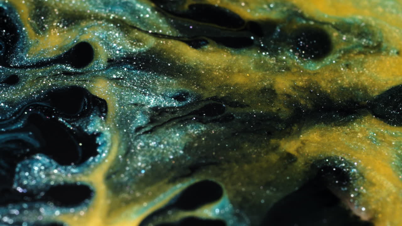 Macro shot of colorful substances mixing in abstract patterns