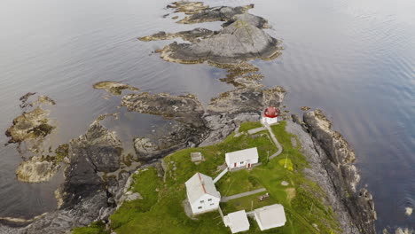 top view of skongenes lighthouse at the edge of the cliff in vagsoy island, vestland county, norway