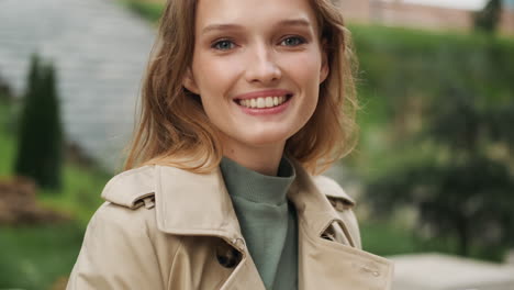 caucasian female student using smartphone outdoors.