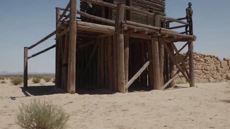 wooden lookout tower in a desert landscape
