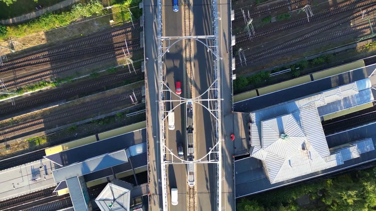 Train runs on tracks at bornholmer street Agent Bridge in berlin, germany summer sunny day. Wonderful aerial view flight drone camera pointing down