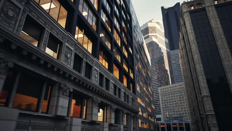 a view of a city street at night with tall skyscrapers