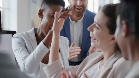 african-american-business-woman-celebrating-with-colleagues-high-five-in-office-meeting-having-fun-celebration-sharing-teamwork-victory-in-workplace