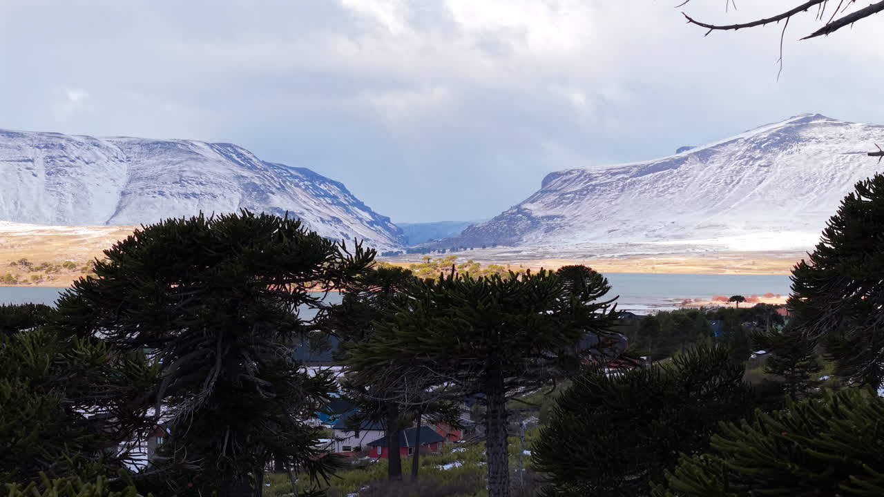 Aerial Drone reveals Patagonian beach Lake, Mountain landscape in Caviahue, Argentina, Neuquen Province, wide skyline