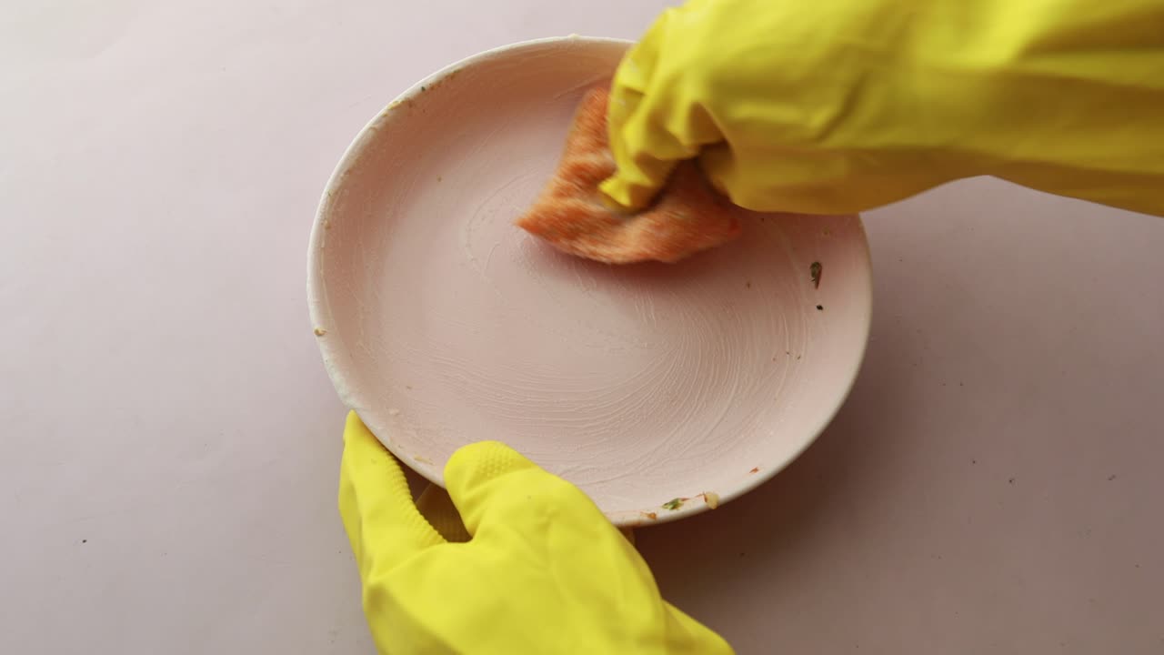 Washing a Dirty Plate with Gloves