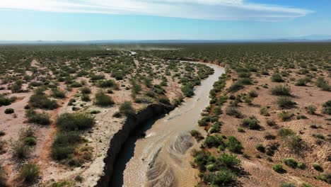 cache creek in the mojave desert flowing with water - aerial flyover