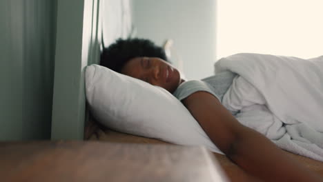 alarm clock, snooze and tired woman sleeping