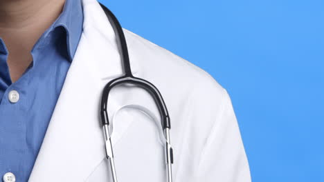 studio shot of male doctor wearing white coat