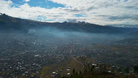 Panoramic view of Cusco city covered in morning haze with mountains in the background. Peruvian Andes, tourism hot spot