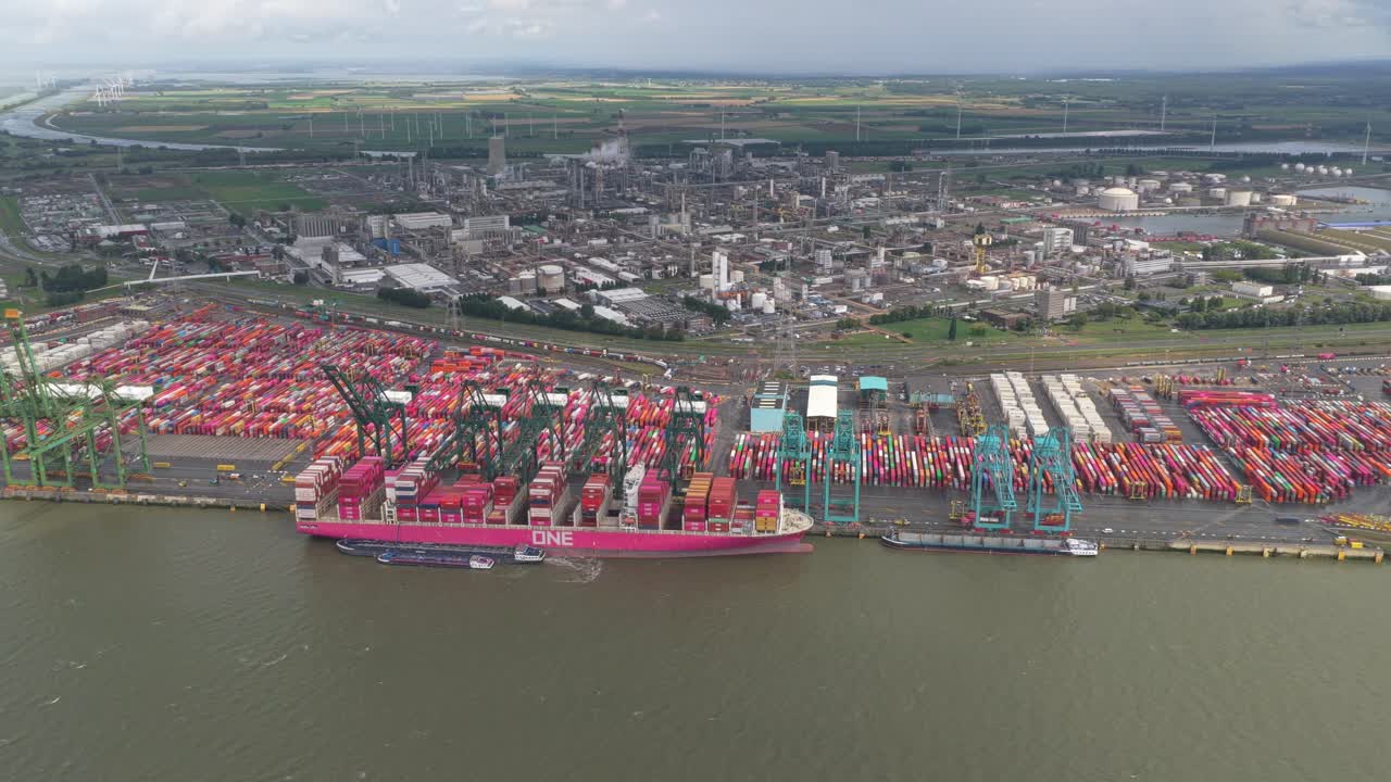 Drone capture of Antwerp port with cranes and container stacks, Belgium