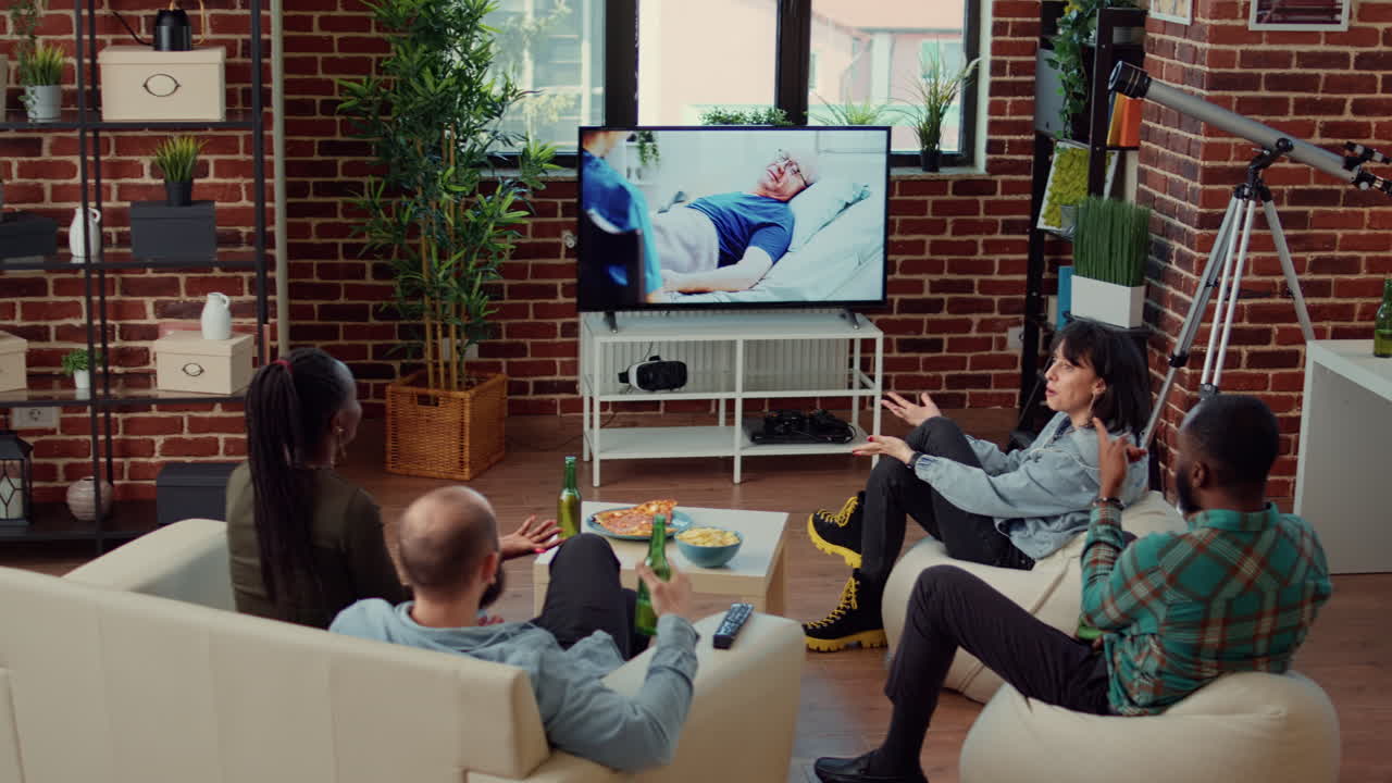 Diverse group of friends enjoying movie on tv channel program