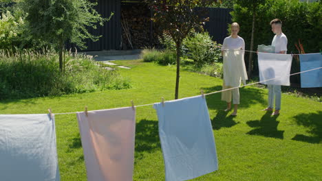 young people drying clothes in the backyard