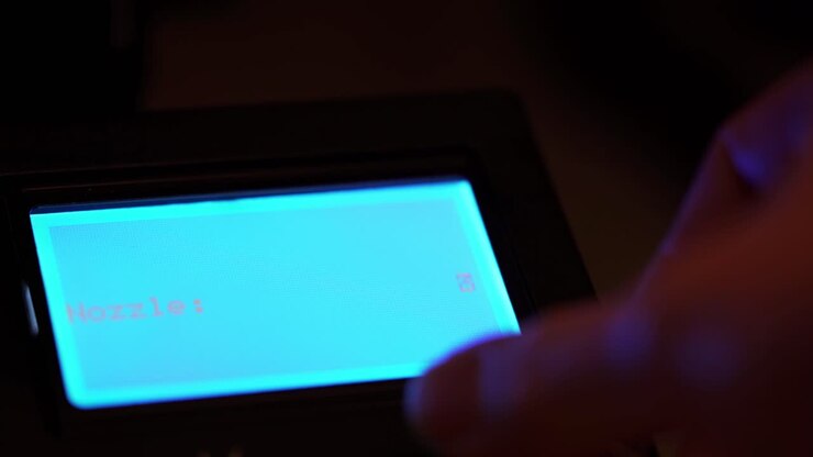 Increasing Nozzle temperature of 3D printer with LCD display lighting blue in the darkness