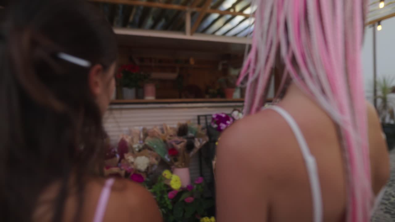 Women with braids at a flower market