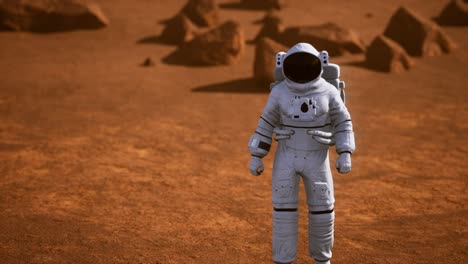 astronauta en la superficie de marte. planeta rojo cubierto de gas y roca