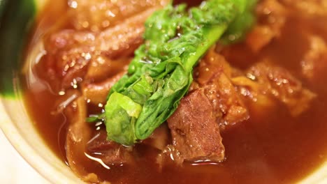 delicious stewed meat noodles with greens