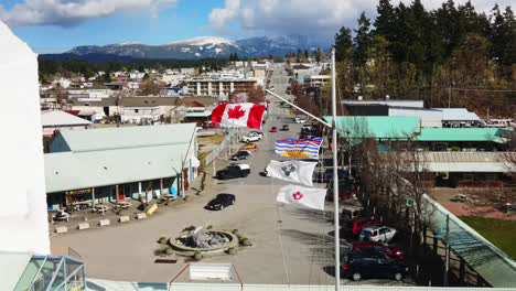 Canadian-Flags-Waving-With-The-Wind-At-The-Marina-In-Port-Alberni,-Vancouver-Island,-BC,-Canada