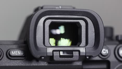 close up of a new camera vizier isolated on grey background. action. viewfinder of a professional photo or video camera