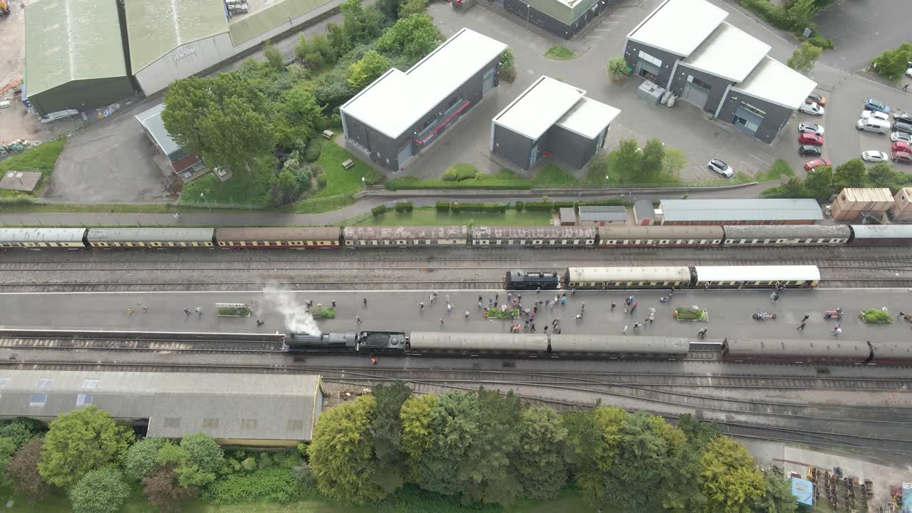 Aerial view of the Minehead steam railway station England's longest heritage line, running 20 miles between Minehead and Bishops Lydeard. Drone steady over the two platforms with two steam trains