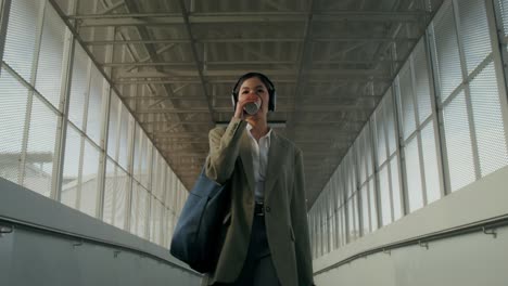 businesswoman walking in a city tunnel