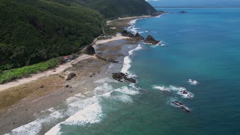 a breathtaking shot captures the serene shoreline, where gentle waves kiss the sandy coast under the vast, open sky.