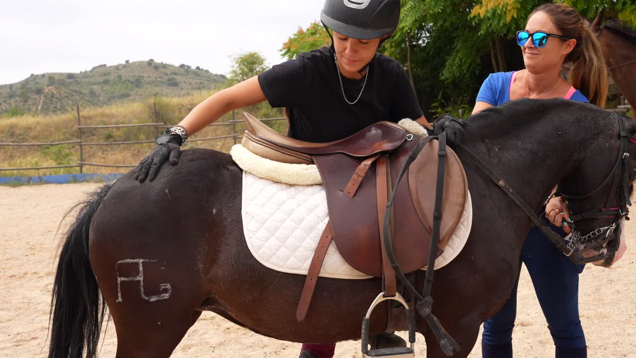 Female rider forms bond with pony by caressing it