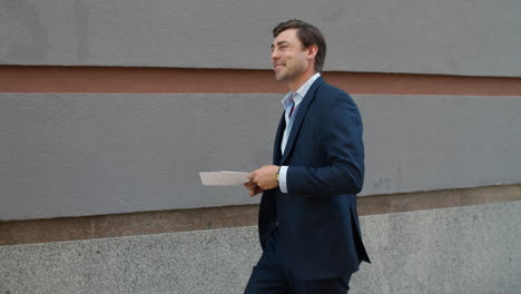 joyful businessman celebrating victory. happy man throwing documents outdoor