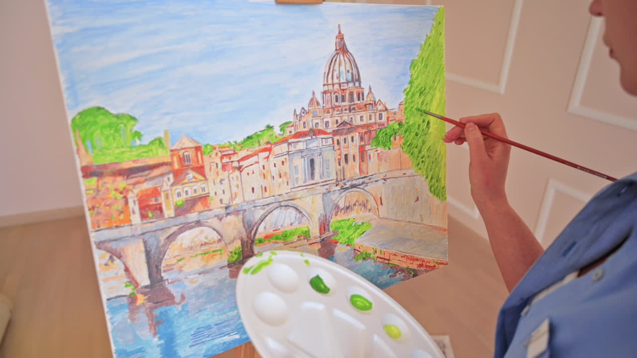 Woman painting picture on the easel holding a palette. Home, slow motion