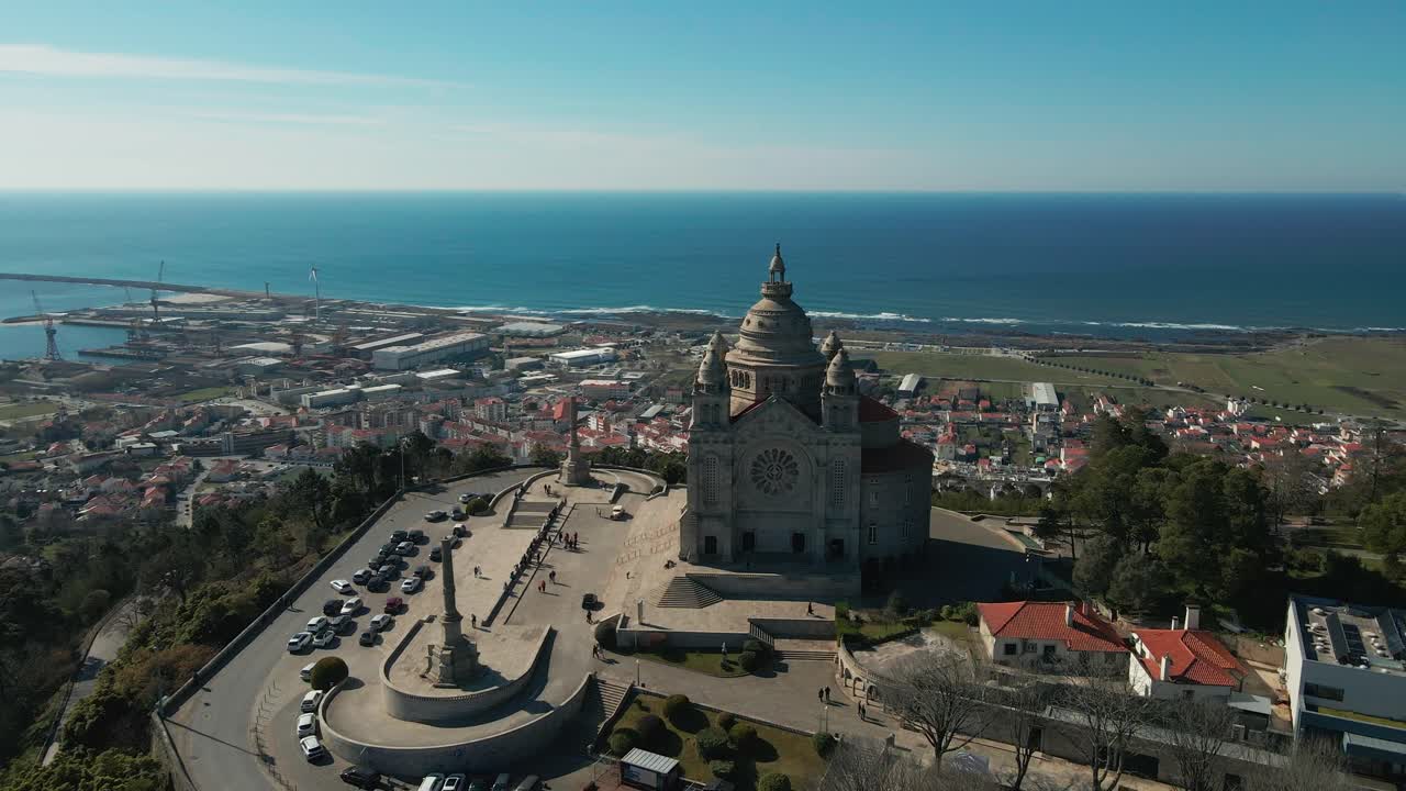 Aerial: Majestic Santa Luzia overlooking Viana's bustling port and serene shores