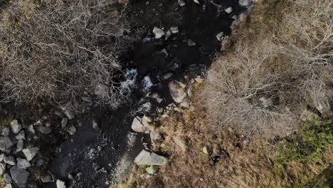 Aerial:-zenital-shot-of-a-river-and-a-path-in-the-mountains-in-late-autumn-or-early-winter