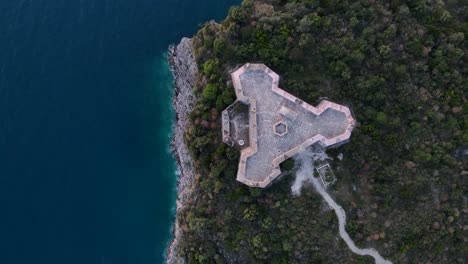 top down aerial ascending of ali pasha venetian triangular castle porto palermo fortress surrounded by a blue ocean