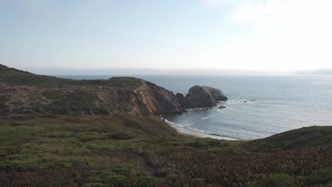 marin headlands in sausalito, california, showcasing sweeping views of rugged hills and the pacific ocean framed by lush greenery and coastal cliffs