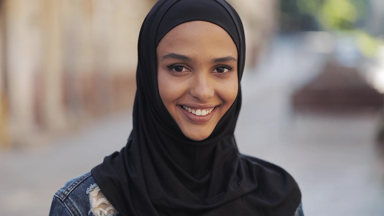 Portrait of a Smiling Young Woman Wearing a Black Hijab