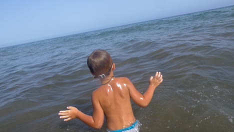 child swimming in the sea